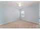 Light blue bedroom with ceiling fan and neutral carpeting at 1057 Princeton Dr, Indian Land, SC 29707