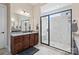 Bathroom with a large shower, granite countertop, and dark wood cabinets at 1132 Cades Ct, Denver, NC 28037