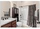 Clean bathroom with shower/tub combo, granite vanity, and dark wood cabinet at 1132 Cades Ct, Denver, NC 28037