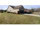 Tan house with a dark brown garage door and lush green lawn at 1132 Cades Ct, Denver, NC 28037