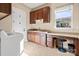 Convenient laundry room with built-in cabinets and workspace at 1132 Cades Ct, Denver, NC 28037