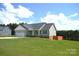 Single-story home with a side-entry garage, green lawn, and a fence defining the landscape at 118 Cypress Acres Ln, Statesville, NC 28625