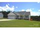 Well-manicured front yard of a single story house featuring a side-entry garage with white trim at 118 Cypress Acres Ln, Statesville, NC 28625