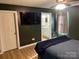 Well-lit main bedroom with ensuite bath, neutral paint and wood floor at 118 Cypress Acres Ln, Statesville, NC 28625