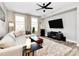 Spacious living room with large windows, a comfortable sofa, and a ceiling fan at 1315 East Blvd # 433, Charlotte, NC 28203