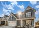 Two story gray house with white accents, landscaping, and a porch at 1844 Giana Ln, Monroe, NC 28112