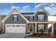 Two-story gray house with white accents, landscaping, and a porch at 1844 Giana Ln, Monroe, NC 28112