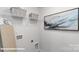 Laundry room with shelving, ironing board, and stylish wall art at 189 Calvin Creek Dr, Troutman, NC 28166