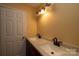 Bathroom featuring a dual sink vanity with light countertops and matching faucets at 206 Fox Den Rd, Troy, NC 27371