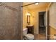 Bathroom featuring a tiled shower, toilet, and vanity with dark wood cabinets at 206 Fox Den Rd, Troy, NC 27371