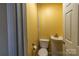 Compact yellow powder room featuring toilet and vanity; ideal for guests on the main level at 206 Fox Den Rd, Troy, NC 27371