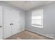 Small bedroom with carpeted floor, closet, and window for natural light at 206 Fox Den Rd, Troy, NC 27371