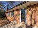 Brick front entrance with decorative glass door and traditional outdoor lighting at 206 Fox Den Rd, Troy, NC 27371