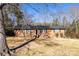 Charming brick home with a well-maintained lawn and mature trees on a sunny day at 206 Fox Den Rd, Troy, NC 27371