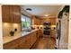 Well-lit kitchen with wood-look floors, stainless steel appliances and wood cabinets at 206 Fox Den Rd, Troy, NC 27371
