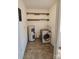 Functional laundry room is equipped with modern washer, shelves, and utility connections at 206 Fox Den Rd, Troy, NC 27371