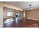 Spacious living room with hardwood floors, natural light, and neutral wall colors at 206 Fox Den Rd, Troy, NC 27371