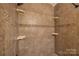 Bathroom shower stall featuring tile surround, mosaic details, and corner shelves at 206 Fox Den Rd, Troy, NC 27371