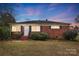 Brick ranch house with front yard, steps and shrubs at 2504 Juniper Dr, Charlotte, NC 28269