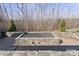 Stone fire pit with seating area in the backyard at 274 Hemlock Bluff Ct, Denver, NC 28037