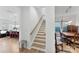 Staircase between the living room and the dining room with natural lighting and neutral tones at 320 Northgate Blvd, Indian Trail, NC 28079