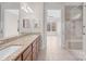 Bright bathroom with double sink, granite countertops, and a glass-enclosed shower at 4774 Looking Glass Trl, Denver, NC 28037