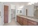 Bathroom with double sinks, large mirror, and a walk-in closet at 4774 Looking Glass Trl, Denver, NC 28037