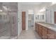 Bathroom featuring a walk-in closet, granite countertop double sink and tiled shower at 4774 Looking Glass Trl, Denver, NC 28037