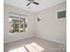 Empty bedroom featuring natural light, neutral walls, and tile flooring at 4774 Looking Glass Trl, Denver, NC 28037