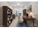 Cozy home office with built-in bookcases, a classic desk, and a comfortable office chair at 4774 Looking Glass Trl, Denver, NC 28037