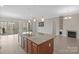 Open-concept kitchen features an island with granite countertops and pendant lighting at 4774 Looking Glass Trl, Denver, NC 28037