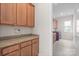 Bright laundry room with wood cabinets, granite countertops, and washer/dryer at 4774 Looking Glass Trl, Denver, NC 28037