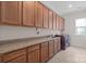 Laundry room with lots of counter space, wood cabinets and modern washer and dryer at 4774 Looking Glass Trl, Denver, NC 28037