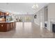 Bright, open-concept living area featuring tile floors, access to the patio, and a cozy fireplace at 4774 Looking Glass Trl, Denver, NC 28037