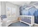 Charming Bedroom with mountain mural, crib, and comfortable armchair at 513 Nantahala Dr, Charlotte, NC 28211