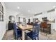 Open concept dining area with wooden table and blue chairs at 513 Nantahala Dr, Charlotte, NC 28211