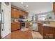 Modern kitchen with stainless steel appliances and wood cabinets at 5430 Allison Ln, Charlotte, NC 28277