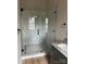 Modern bathroom featuring a glass-enclosed shower with decorative tile and a granite vanity at 5743 Selkirk Dr, Hickory, NC 28601