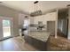 Modern kitchen with stainless steel appliances, center island, and access to outdoor deck at 5743 Selkirk Dr, Hickory, NC 28601