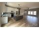 Open-concept kitchen with granite countertops, a large island, and white cabinetry at 5743 Selkirk Dr, Hickory, NC 28601