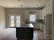 Bright kitchen features stainless steel appliances, granite counters, island, and backyard access at 5743 Selkirk Dr, Hickory, NC 28601
