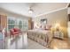 Bright bedroom with ample natural light, ceiling fan and a comfy sitting area at 5981 Bison Ct, Fort Mill, SC 29707