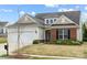 Charming home featuring a two-car garage and manicured lawn at 5981 Bison Ct, Fort Mill, SC 29707