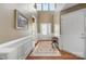 Charming foyer with a hardwood floor, beautiful rug, and natural light streaming through the door and transom windows at 5981 Bison Ct, Fort Mill, SC 29707
