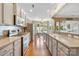 Bright kitchen featuring modern appliances, lots of cabinets, hardwood floors, and an open layout flowing into the dining area at 5981 Bison Ct, Fort Mill, SC 29707