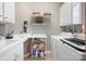 Functional laundry room with white cabinetry, sink, countertop, and washer and dryer at 5981 Bison Ct, Fort Mill, SC 29707