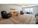Spacious living room featuring neutral walls, carpeted floor, ceiling fan, and comfortable furniture set at 5981 Bison Ct, Fort Mill, SC 29707