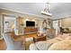 Bright and inviting living room with comfortable seating and stylish décor and open access to the hallway at 5981 Bison Ct, Fort Mill, SC 29707