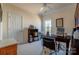 Cozy home office featuring neutral walls, carpeted floors, ceiling fan, natural light from the window and dark wood desk at 5981 Bison Ct, Fort Mill, SC 29707