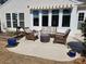 Outdoor patio area featuring wicker seating, neutral siding, awning, and lush greenery at 5981 Bison Ct, Fort Mill, SC 29707